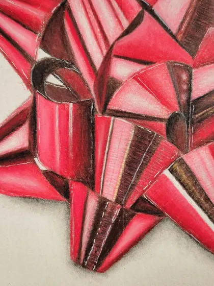 A close-up of the intricate folds and highlights on the red gift bow.