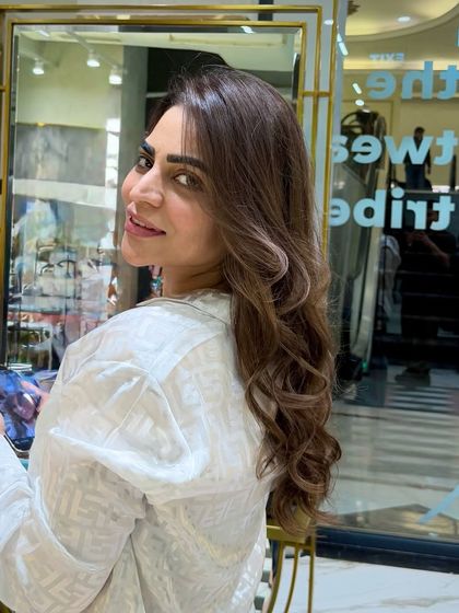 Embracing the cool side with this smoky ash blend. The color is rich and dimensional, and the soft curls add a touch of glamour.