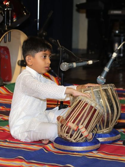 A side profile of Reyansh during his tabla solo, showing his focus and dedication.
