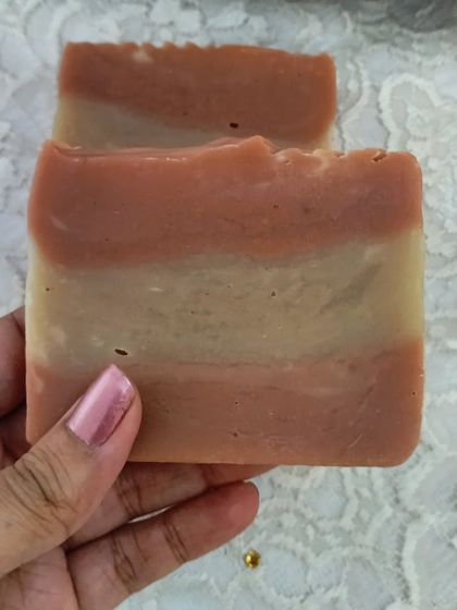 Holding a bar of the Harmony soap. The blend of butters makes it incredibly moisturizing, while the essential oils transport you.