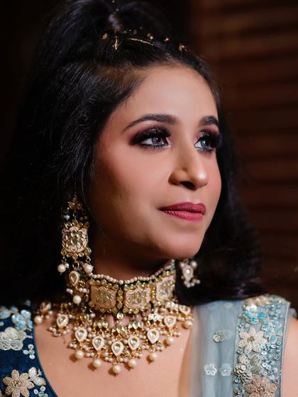 A detailed shot of the client's engagement makeup and jewellery, focusing on the beautiful kundan and pearl choker set.