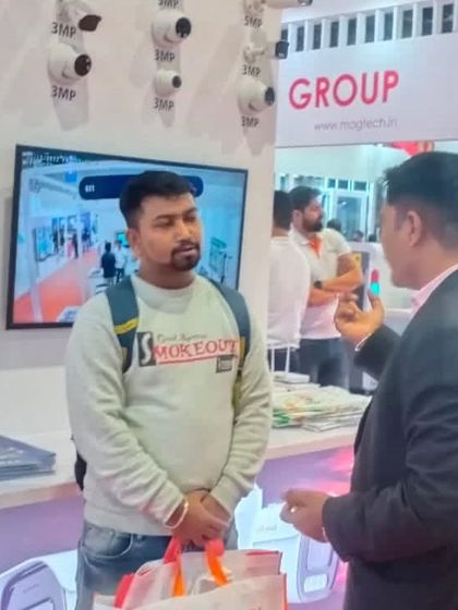 Discussing the latest camera technology with an expert at a security expo. I am always learning about new products to ensure I can offer my clients the best possible solutions.