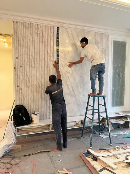 Precision is everything. Here, our team is installing a statement wall, ensuring every panel aligns perfectly. This is where our design-and-build model shines; the same team that envisions the detail also executes it flawlessly on site.