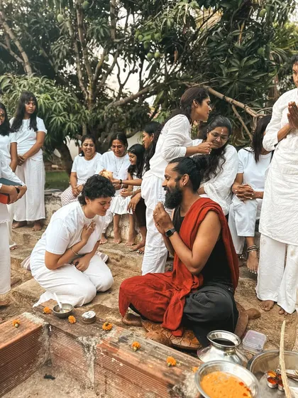 Students bow in reverence during a ceremony, showing respect for the teachings and the divine. This humility is a key aspect of the yogic path.