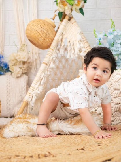 A playful crawling shot on the jute rug. The natural textures and soft lighting of the boho theme create a perfect backdrop for capturing these active moments.