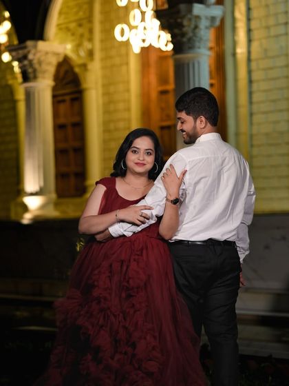 A romantic moment captured near our grand architectural set, with modern ring lights adding a contemporary touch to the night.