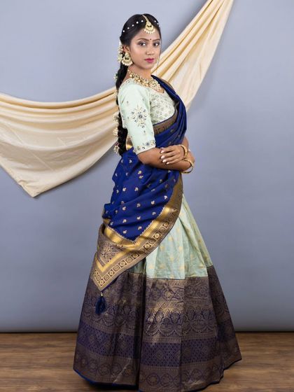 A side view of the South Indian style lehenga, highlighting the rich texture of the silk and the heavy zari border.