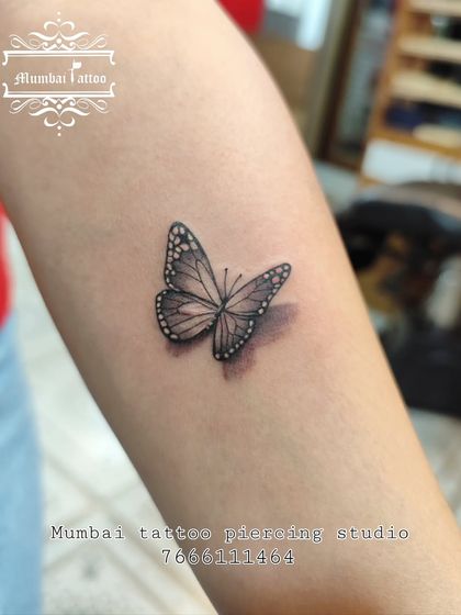 A close-up shot of the 3D butterfly tattoo, highlighting the delicate shading and dotwork that create the realistic effect. This level of detail is what we strive for in every piece.