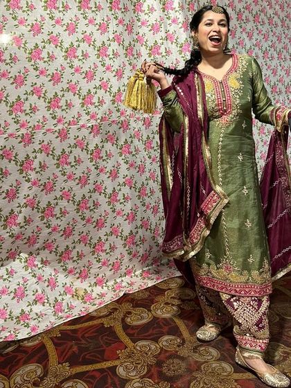 A full-length shot of the festive Punjabi suit, perfect for a Lohri celebration. The rich colors, heavy embroidery on the salwar, and traditional juttis create a complete and authentic look.