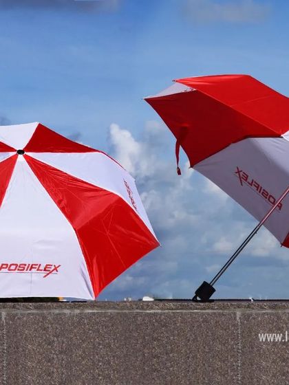 Don't let the rain stop you. We also offer custom-branded umbrellas, like these red and white ones we made for Posiflex, perfect for corporate events or as a practical giveaway.
