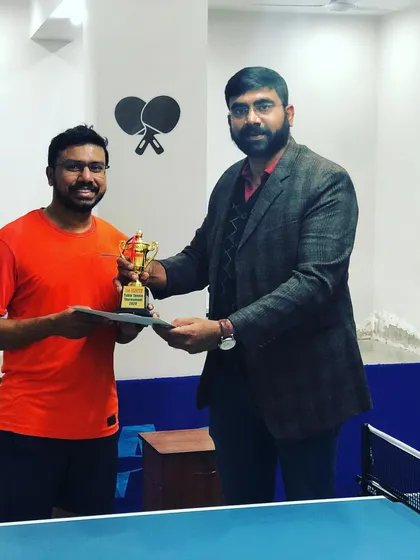 Celebrating a champion at our prize money tournament. We believe in rewarding skill and dedication, with trophies and cash prizes for top performers.