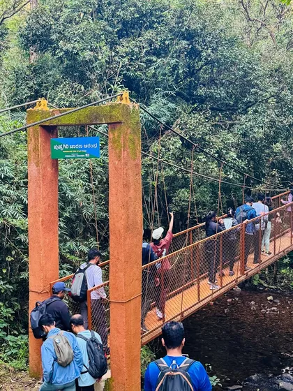 Trekkers crossing the Pushpagiri trek start point bridge. Kumara Parvatha is also known as Pushpagiri.