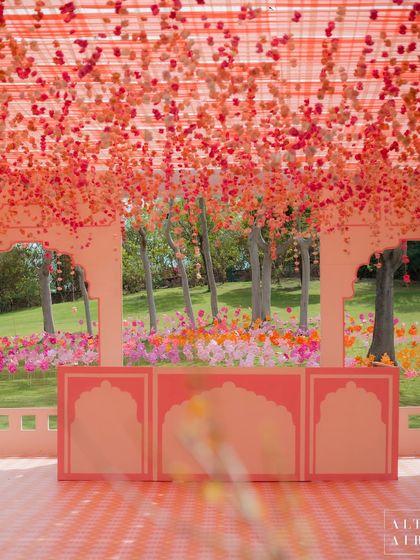 The bar at the 'Gulbahar' celebration featured a stunning ceiling installation of falling bougainvillea, creating a canopy of color. The design was bright, fun, and perfect for kicking off the wedding festivities.