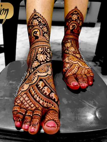 A bride's look is complete only with beautiful mehndi on her feet. This is an example of my detailed foot mehndi, featuring traditional peacock and elephant figures, which are symbols of grace and strength. The fine lines and shading show the level of detail I bring to every part of the bridal package.