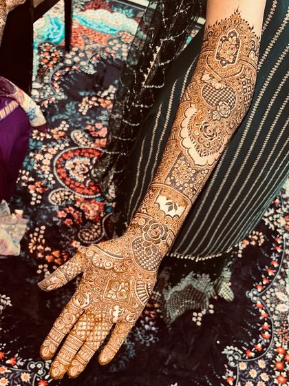 A close-up of the arm, highlighting the intricate details of the Pakistani-style patterns.