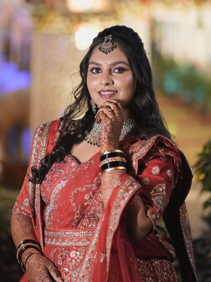 A lovely portrait of Amrutha at her reception. Her soft glam makeup, featuring a warm-toned eyeshadow and nude-pink lip, enhances her natural features.