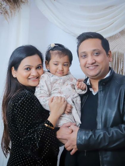 A sweet portrait of the parents with their youngest daughter in our studio.
