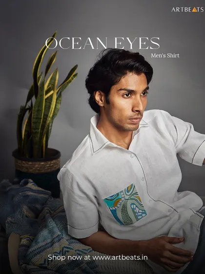 The Ocean Eyes men's shirt. Crafted from white linen, this shirt features a pocket with a detailed, wave-like art pattern, perfect for those who feel a connection to the sea.