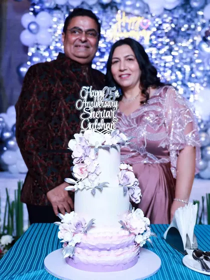 The happy couple celebrating their 25th anniversary with their custom-designed cake. It's always wonderful to see our creations become part of such special memories.