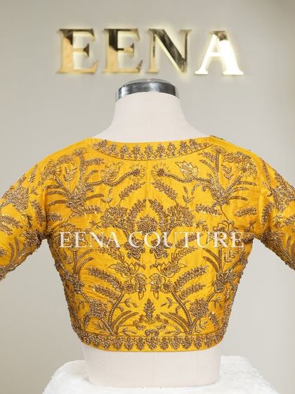 This sunshine yellow raw silk blouse is brought to life with meticulous hand embroidery by my talented artisans. The dense, traditional motifs in antique gold threadwork cover the back and sleeves, creating a piece that radiates warmth and luxury.