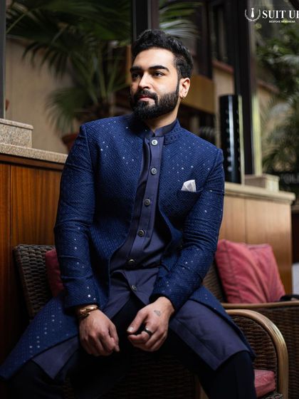 A relaxed portrait of the client in his custom navy ensemble, proving that style and comfort can go hand-in-hand.
