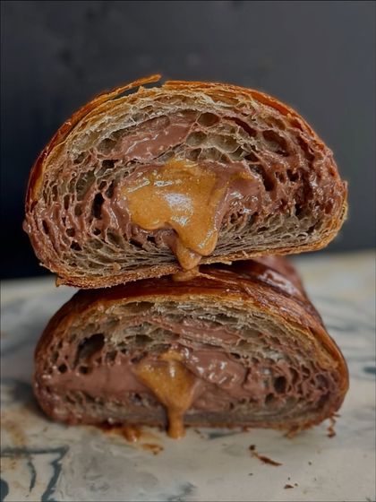 The gooey, delicious cross-section of a chocolate croissant filled with a rich hazelnut praline. This was a weekend experiment that our guests absolutely loved.