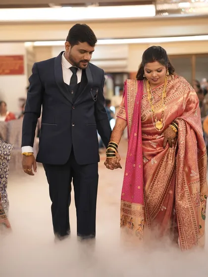 Another shot of the couple's entrance, showing the beautiful drape of the bride's saree and her elegant look.