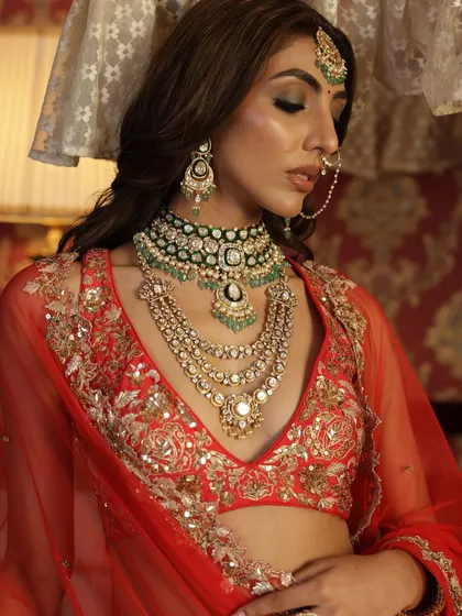 A close-up on the stunning layered necklaces, a key part of creating a truly royal bridal look. The combination of polki and emeralds is a classic choice.