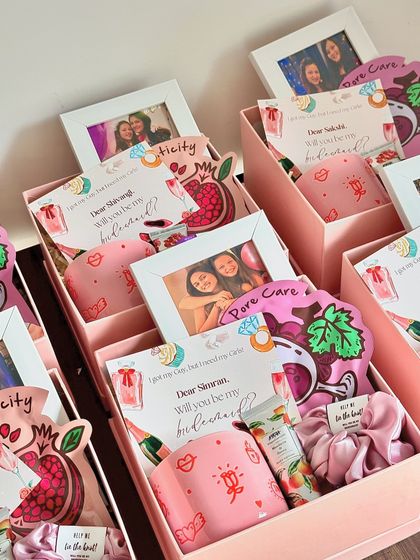 A collection of our bridesmaid hampers, each with a personalized photo frame and a custom card to make the proposal extra special.