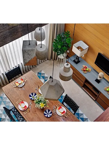 We use scale and light to create dramatic yet comfortable spaces. The double-height dining area in the Nataraj House is illuminated by a skylight, with custom concrete pendant lights drawing the eye and enhancing the sense of volume and openness.