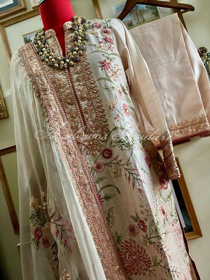 A mannequin shot providing a clear perspective of the suit's silhouette and the drape of the dupatta.