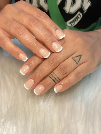 A classic French manicure on short, natural square nails. This shows that you don't need long extensions to enjoy a clean, polished, and professional look.