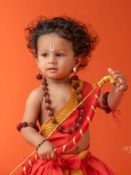 A close-up portrait of a child as Lord Ram, focusing on his expressive face and traditional attire. The details, like the tilak and rudraksha beads, are captured with clarity.