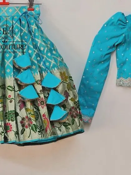 A beautiful long-sleeved blouse and lehenga set. This can be paired with a matching outfit for a mother or sister.