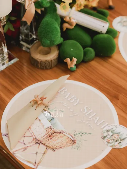 A custom-printed placemat and napkin ring for the woodland baby shower.