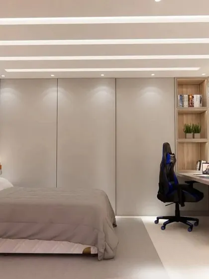 This view shows the full-height wardrobe with handleless doors, which provides ample storage while maintaining a clean, minimalist look.