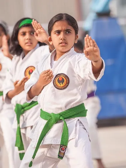 Focus is the foundation of karate. Here, a young green belt student demonstrates her concentration while practicing kata. We start training children from age 5, instilling discipline and an anti-bullying attitude from the very beginning.