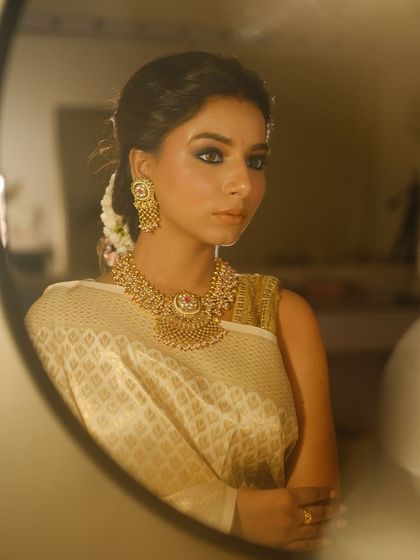 A mirror shot capturing the timeless elegance of this look. A classic smokey eye paired with a nude lip is a combination that never fails.