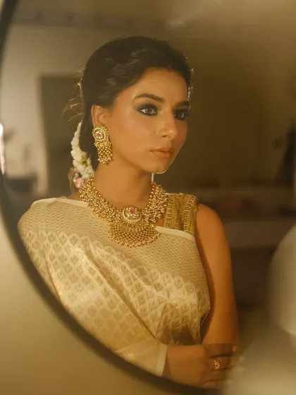 A mirror shot capturing the timeless elegance of this look. A classic smokey eye paired with a nude lip is a combination that never fails.