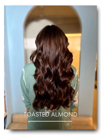 'Toasted Almond' is a sophisticated and subtle hair color. It combines a neutral brown base with very fine, lighter highlights for a gentle, dimensional look that is both modern and timeless.