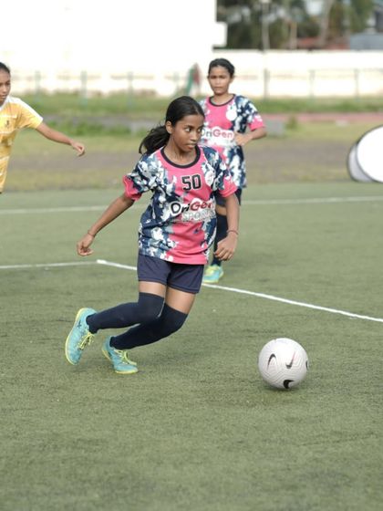 A young player from our U16 girls' team dribbling with confidence and control during a competitive match.