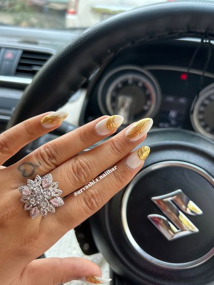 A striking design featuring a matte white base with textured gold chrome accents. The contrast between the simple white and the metallic gold creates a modern and luxurious look.