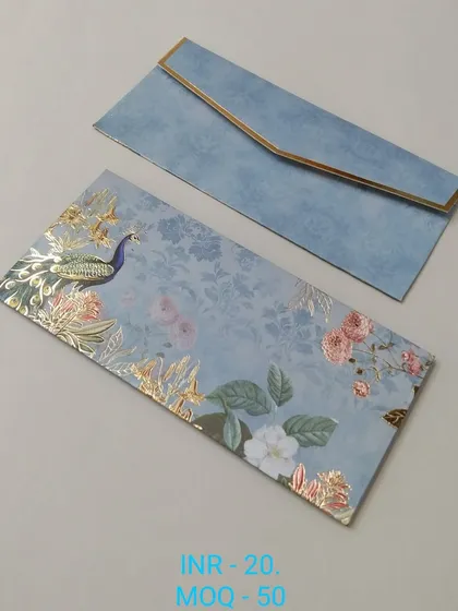 An elegant money lifafa in a textured blue, decorated with a beautiful peacock and floral patterns in gold foil. The design is subtle yet luxurious, suitable for any special occasion.