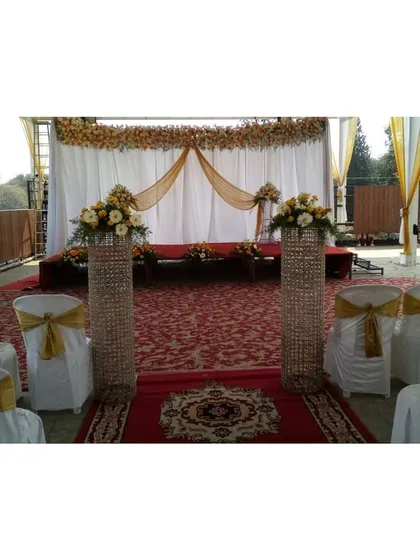 A beautiful terrace event setup. We used a red carpet aisle, crystal pillars, and elegant seating with gold sashes to create a formal and celebratory atmosphere for this lockdown event.