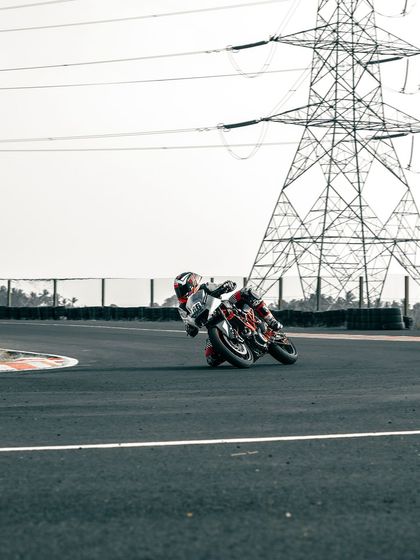 A rider on a KTM cornering on the track.