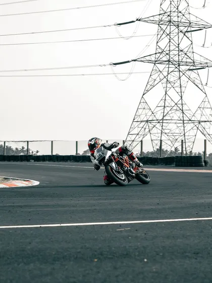 A rider on a KTM cornering on the track.