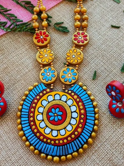 The same mandala and floral bead necklace, here in a striking blue, red, and yellow palette.