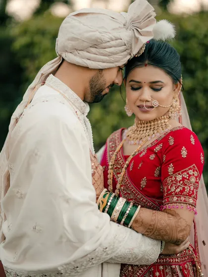A close up portrait focusing on the couple's gentle embrace and the bride's beautiful traditional Maharashtrian jewelry.