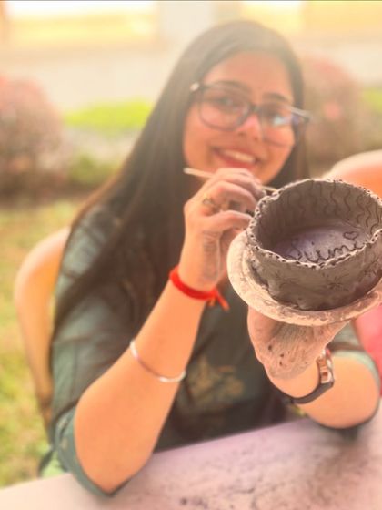 A proud maker showing off her hand-built bowl. In my workshops, the focus is on the process, not perfection, which allows everyone to create something they love.