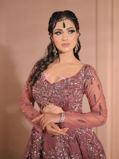 A confident pose showing off the complete party look. The makeup, hair, and outfit all come together to create a cohesive and stunning style.